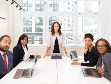 woman-standing-on-the-center-table-with-four-people-on-the-1367271 woman-standing-on-the-center-table-with-four-people-on-the-1367271